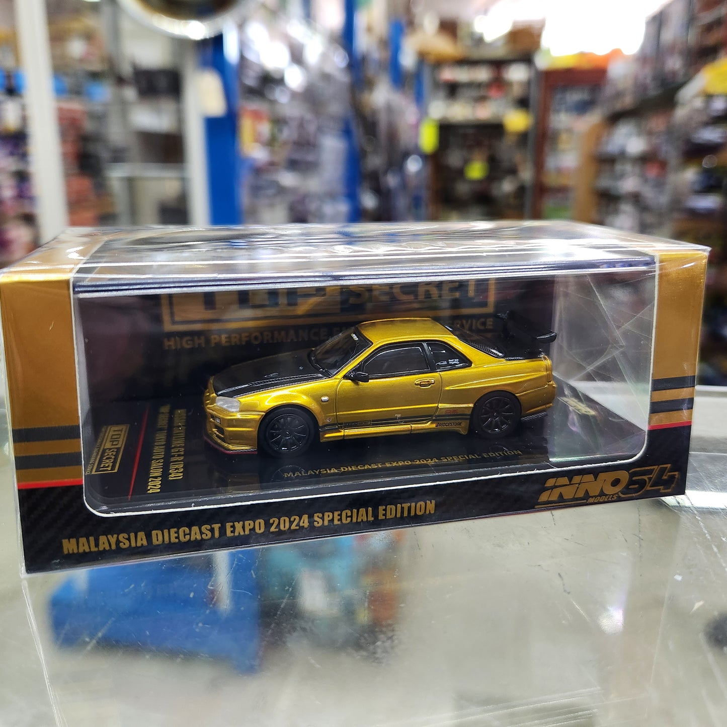 INNO64 - Nissan Skyline GT-R (R34) Top Secret Tokyo Auto Salon (Gold)- 1:64 Scale