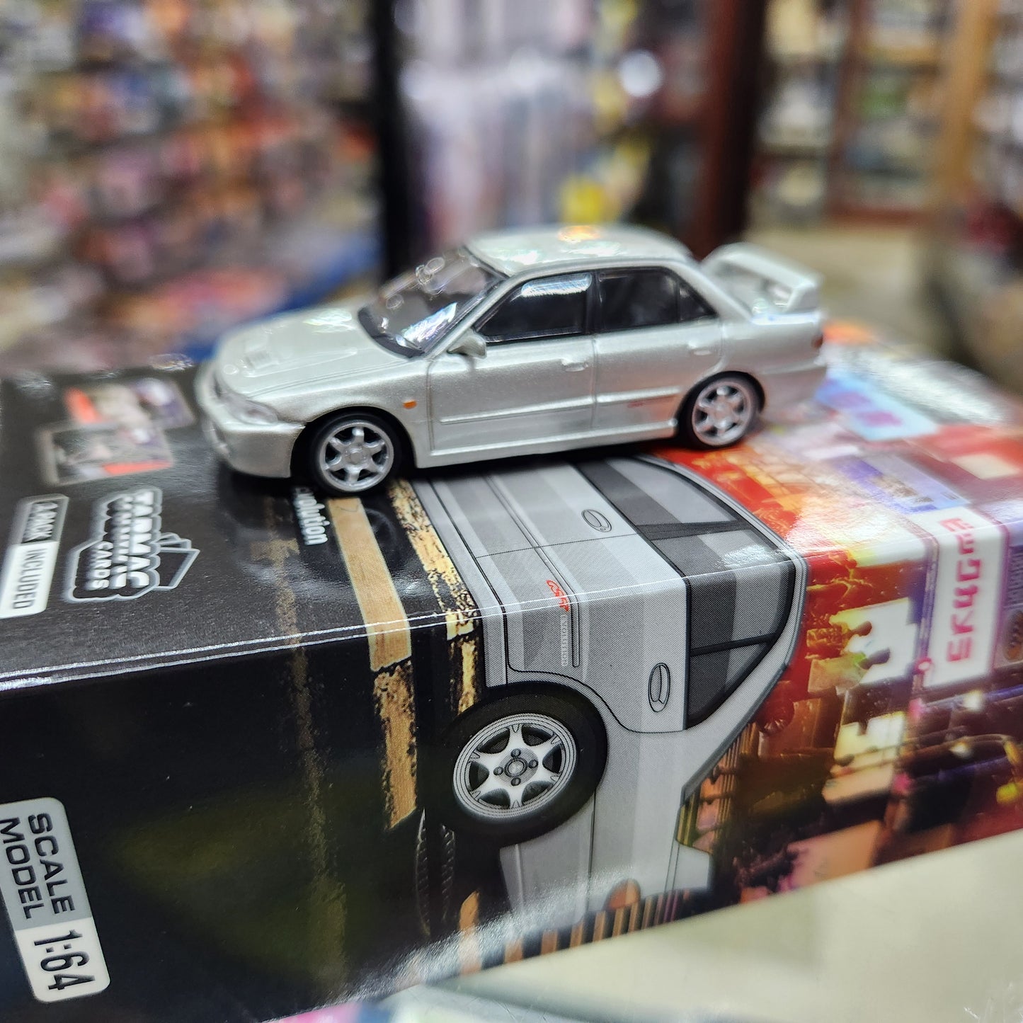 Tarmac Works - Mitsubishi Lancer GSR Evolution Silver (With Cards) - 1:64 Scale