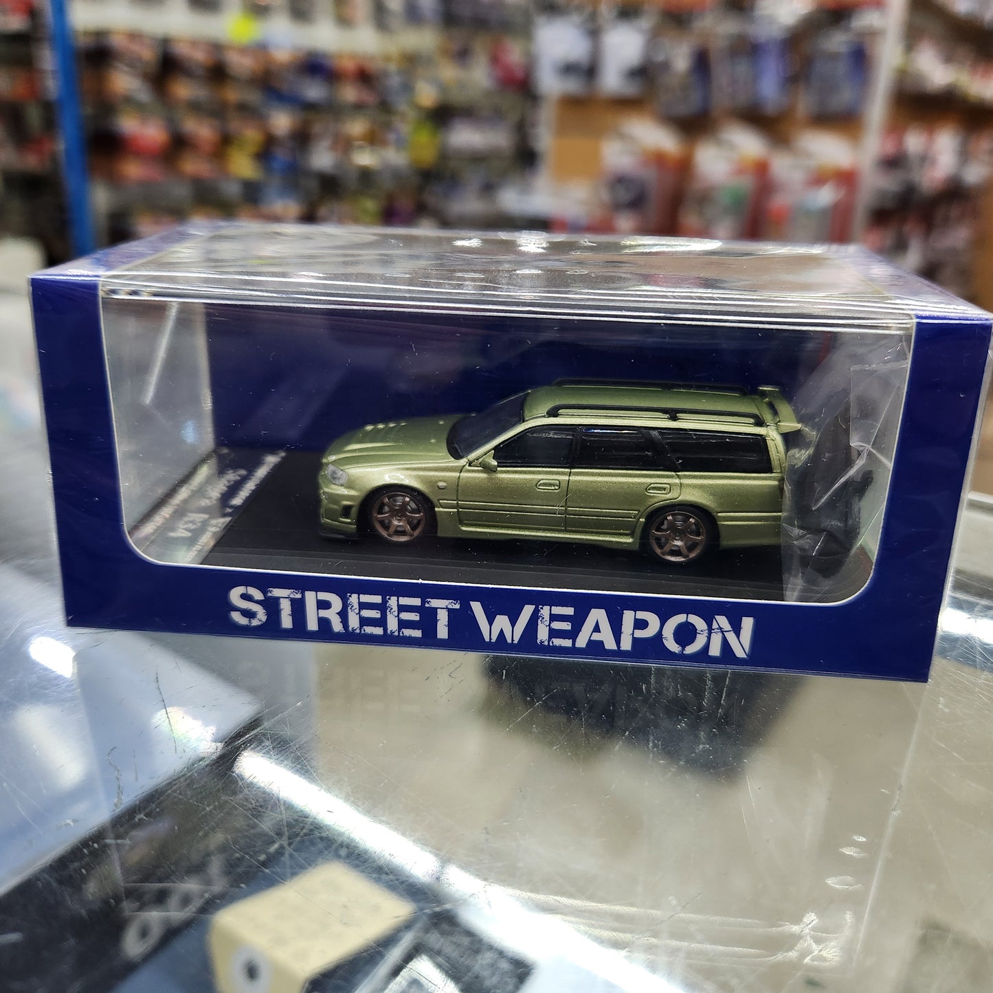 Street Weapon - Nissan Stagea (R34) Olive Green - 1:64 Scale